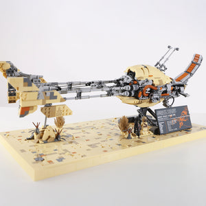 Full view of MOC-BW3001 - Kintan Strider Speeder Bike made with LEGO® bricks on desert scene with a vehicle and figures on a white background.
