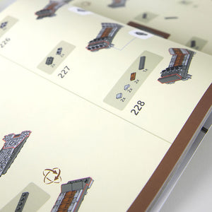 Close-up of manual flipped to a page showing steps and pieces required to build the Kintan Strider Speeder Bike's Seat with LEGO® bricks.