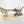 Full view of MOC-BW3001 - Kintan Strider Speeder Bike made with LEGO® bricks on desert scene with a vehicle and figures on a white background.
