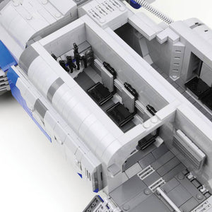 Close-up of a detailed model spaceship with interior compartments on a white background